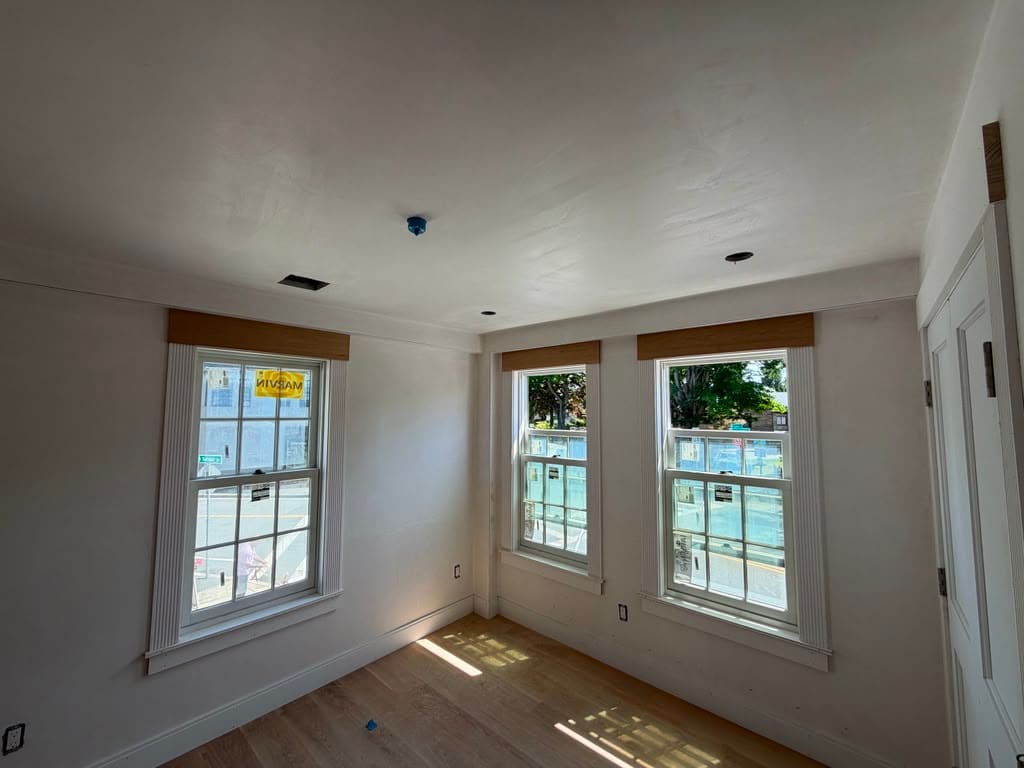 Oak boards laid across a corner room with windows on two walls