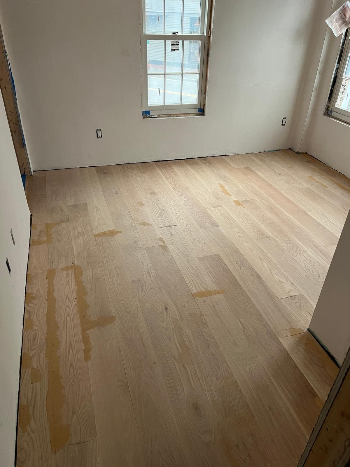 Wide white oak boards across a finished room