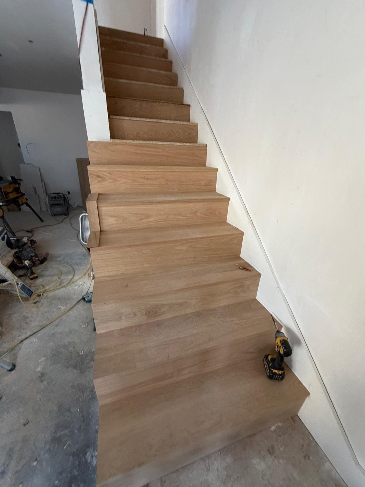 Straight flight of white oak treads before the railing goes on